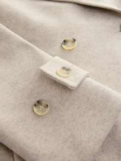 - Lange maxi-jas*Next Best