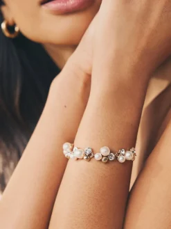 Goudkleurig - Doorgetrokken armband met pareleffect en glitters*Next