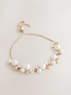 Goudkleurig - Doorgetrokken armband met pareleffect en glitters*Next