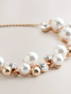 Goudkleurig - Doorgetrokken armband met pareleffect en glitters*Next