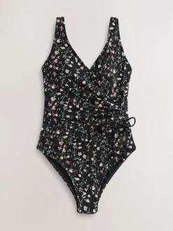 Zwart met broderie en fijne print - Badpak met vormgevende zijrimpeling en buikcorrectie*Next Clearance