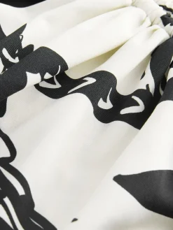 Zwart/Crème Palm - Badpak met vormgevende zijrimpeling en buikcorrectie*Next New