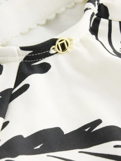 Zwart/Crème Palm - Badpak met vormgevende zijrimpeling en buikcorrectie*Next New