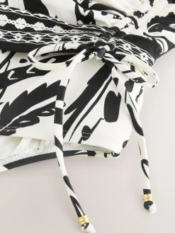 Zwart/Crème Palm - Badpak met vormgevende zijrimpeling en buikcorrectie*Next New