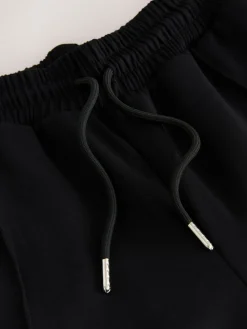 Zwart/neutraal - Slinky trainingsbroek met wijde pijpen en zijstrepen*Next Outlet